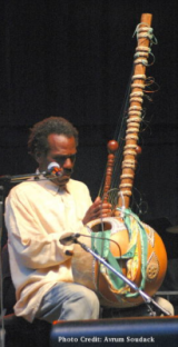 Celso Machado playing kora Photo Credit: Avrum Soudack