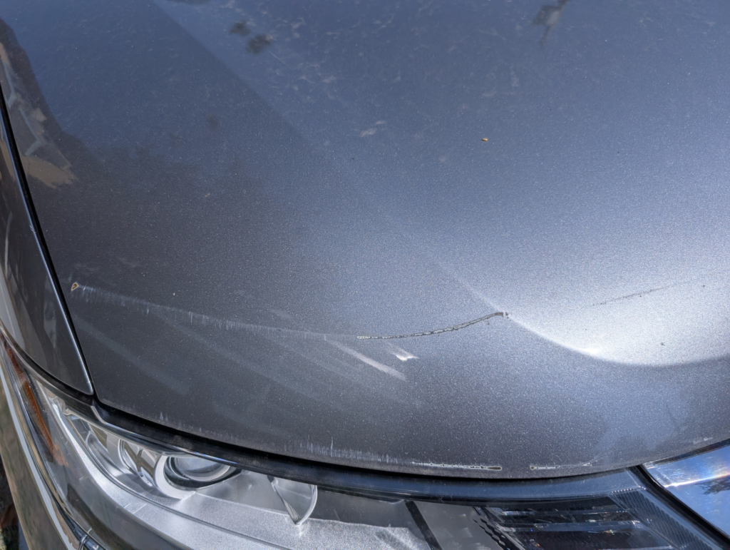 Passenger hood scrape